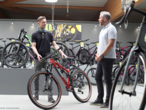 Gunnar_Schmidt_Bike_Coach-Gespraech-mit-einem-Fahrradverkäufer