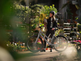 Frau mit E-Bike Ampler Juna vor Blumenladen
